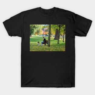 Young woman with her dog and phone in the park T-Shirt